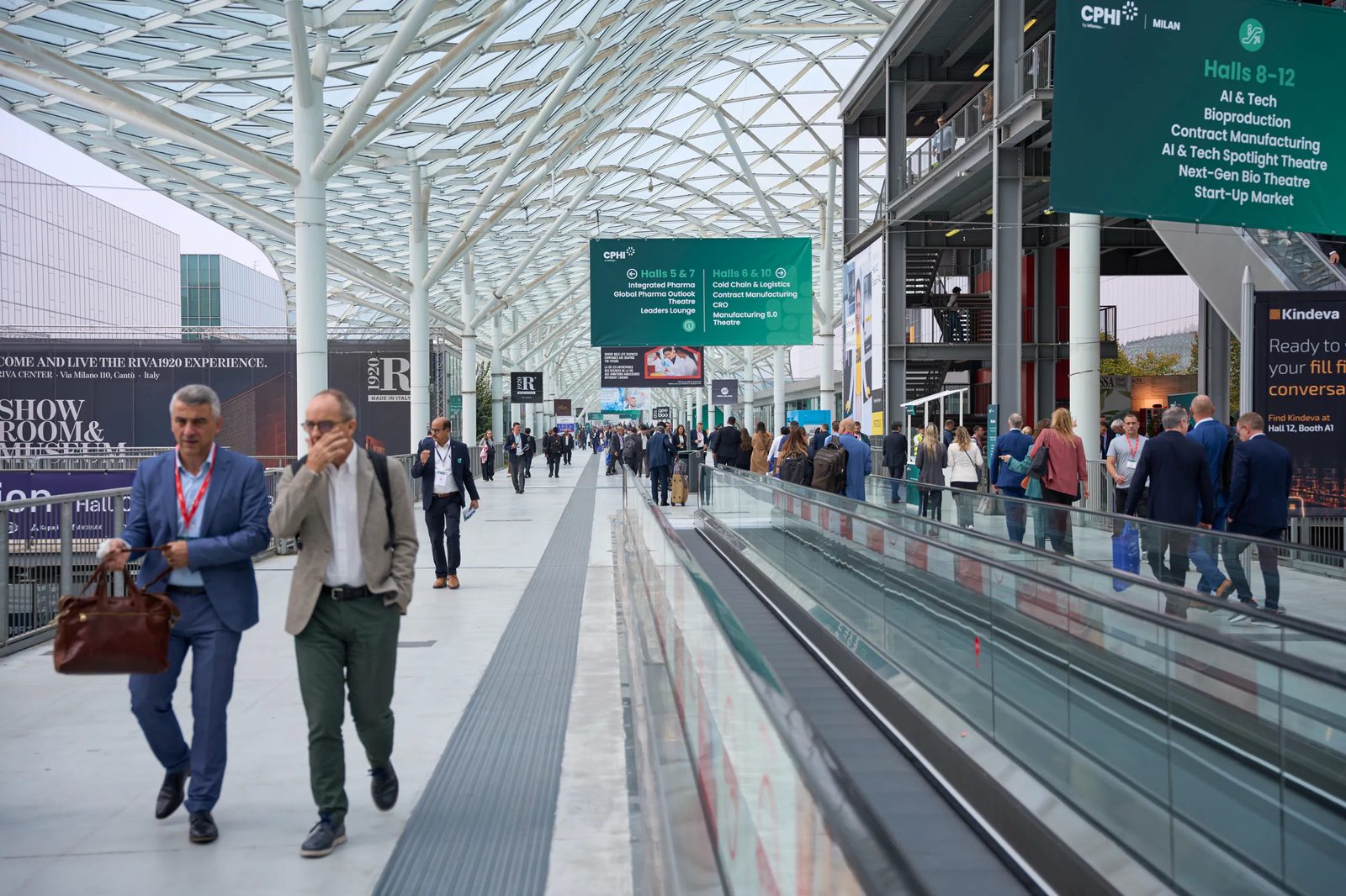 Visitors and signage along the Fiera Milano Rho concourse