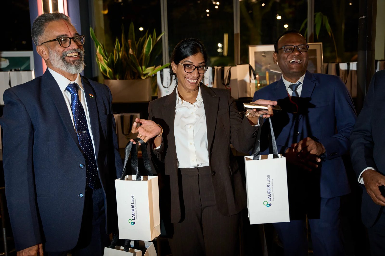 Guests holding Laurus Labs bags at the end of the evening